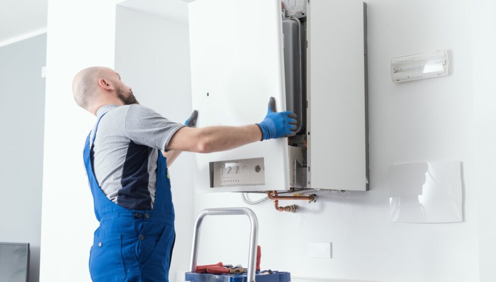 Professional engineer doing a boiler inspection at home