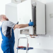 Professional engineer doing a boiler inspection at home